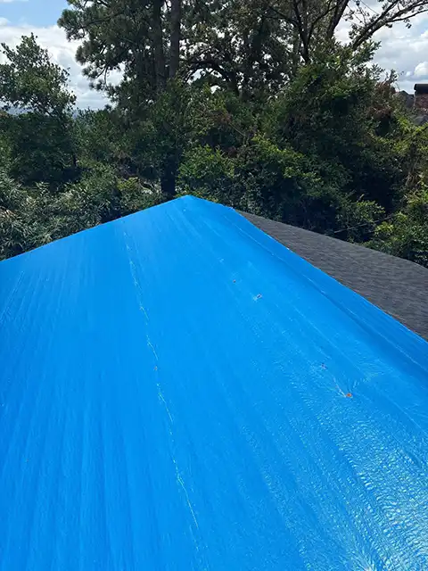 Home with storm damage and tarp in Birmingham